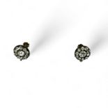 A pair of Edwardian screw back paste cluster earrings. Featuring silver fronts and yellow metal