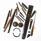 A collection of tortoiseshell handles, cigarette holder ends and other items, plus two wooden cane