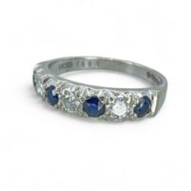 An 18ct white gold sapphire and diamond half hoop ring. Pave set with three round brilliant cut
