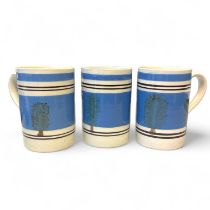 Three large Mochaware slip decorated earthenware tankards featuring a tree 'dendritic' pattern. On a