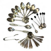 A collection of silver teaspoons. To include a set of twelve sterling silver teaspoons with sun/