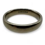 An 18ct white gold band ring. Size P. Band width 4.6mm, weight 8.18 grams. Slight bending to shape.