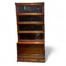 A Globe Wernicke mahogany stacking bookcase with five glazed sections with a base drawer.