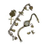 A 9ct gold charm bracelet with seven charms attached and a detached heart padlock and two further