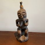 ***AWAY*** A carved African tribal figure approximately 18cm by 20cm by 54cm tall.