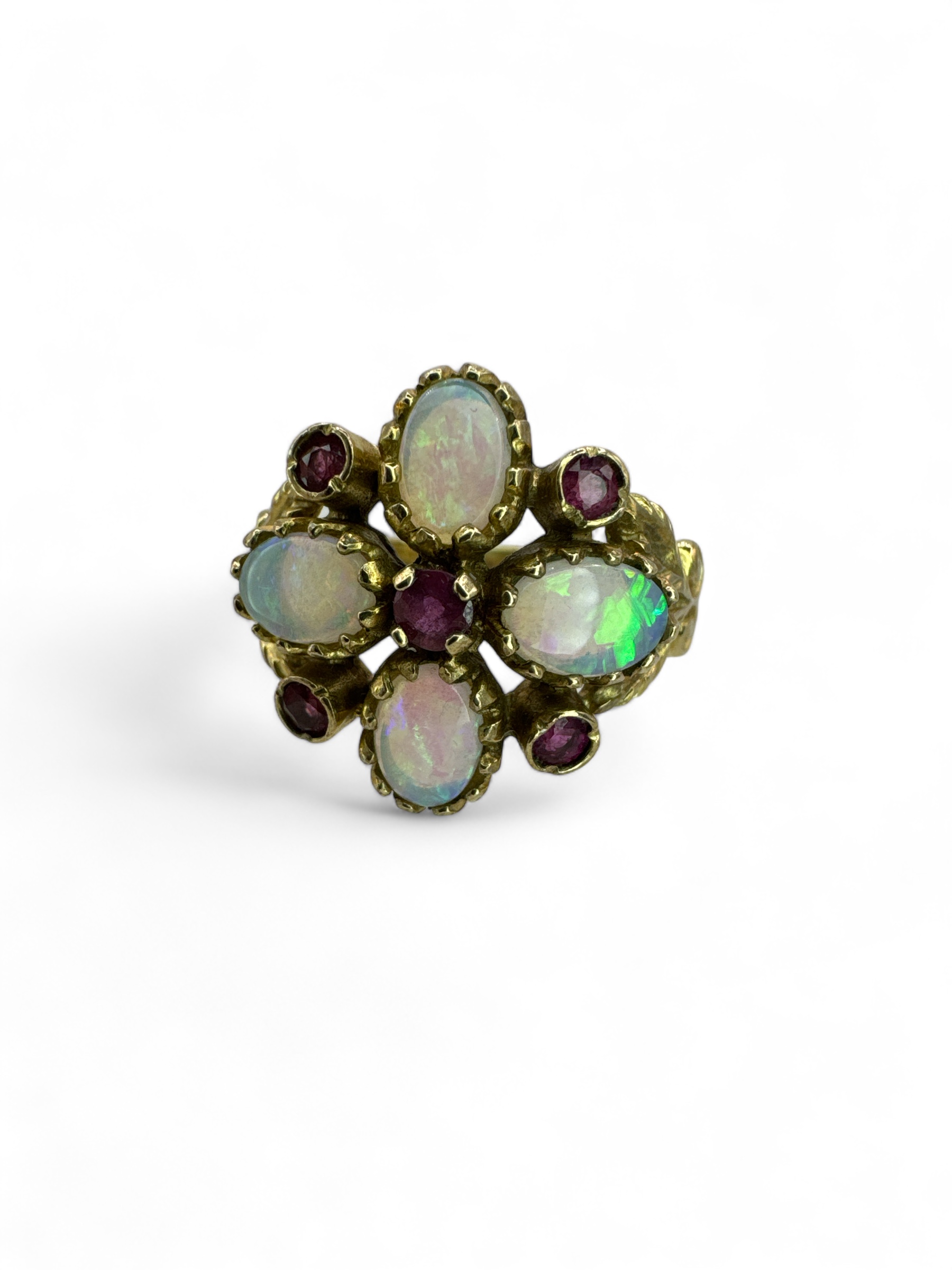 An opal and ruby set quatrefoil ring in 9ct yellow gold, with gold scroll work. Size N. Gross weight