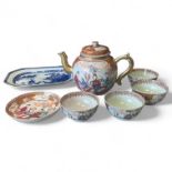 A Chinese 19th Century Famille Rose part tea set to include teapot, four tea bowls and a saucer.