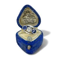 An early 20th century old mine cut diamond and sapphire ring. Shank stamped "18ct  Plat" and tests