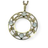 A aquamarine and seed pearl set wreath pendant in yellow precious metal, marked "9", testing as