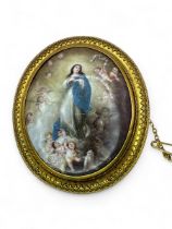 A Victorian yellow metal brooch set with an enamel plaque after the Immaculate Conception by