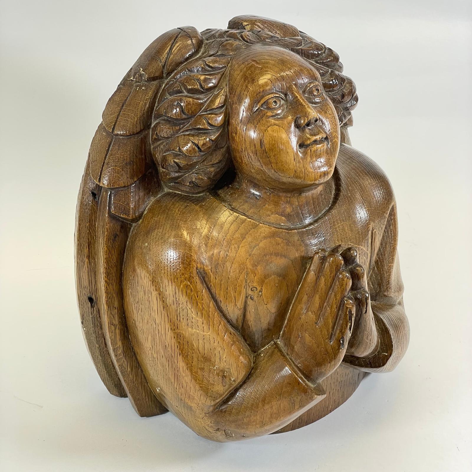 A carved oak Angel boss 27cm x 18cm x 30cm