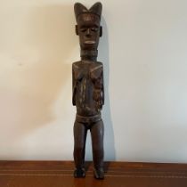 ***AWAY*** A carved African tribal standing figure with male child approximately 16cm by 15cm by