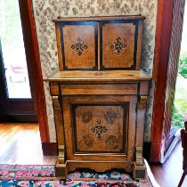 A Victorian Burr Walnut Ebonised Davenport with a fitted Upstand above a writing drawer and cupboard