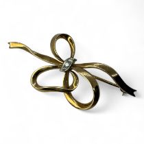 A diamond set 1950s style vintage ribbon bow brooch, stamped CR 585 and testing as 14ct gold. Set