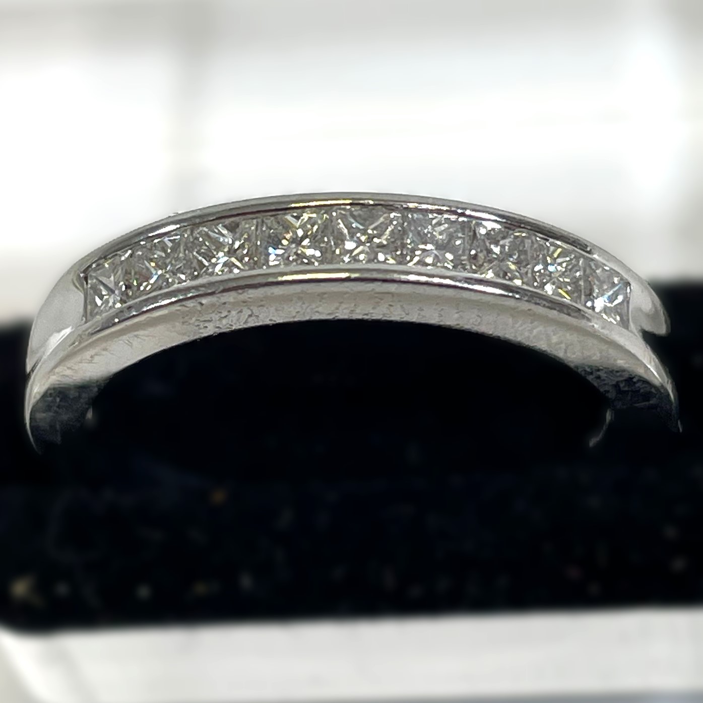 A 950 Platinum channel set diamond half eternity ring. Set with nine princess cut diamonds, - Image 2 of 5