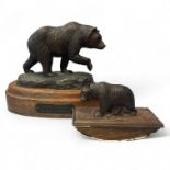 A bronze figure of a grizzly bear by Steven & Lillegard on a wooden base 21cm tall and a black