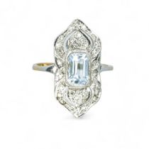 A 9ct gold topaz and diamond panel ring in the Art Deco style. Featuring a central emerald step cut,