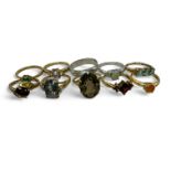 A collection of 9 gem set rings in hallmarked gold, together with a 9ct gold band ring.