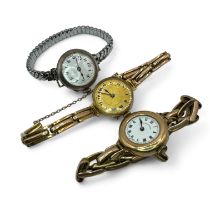 A group of three early 20th century wrist watches in 9ct gold and silver. To include two 9ct gold