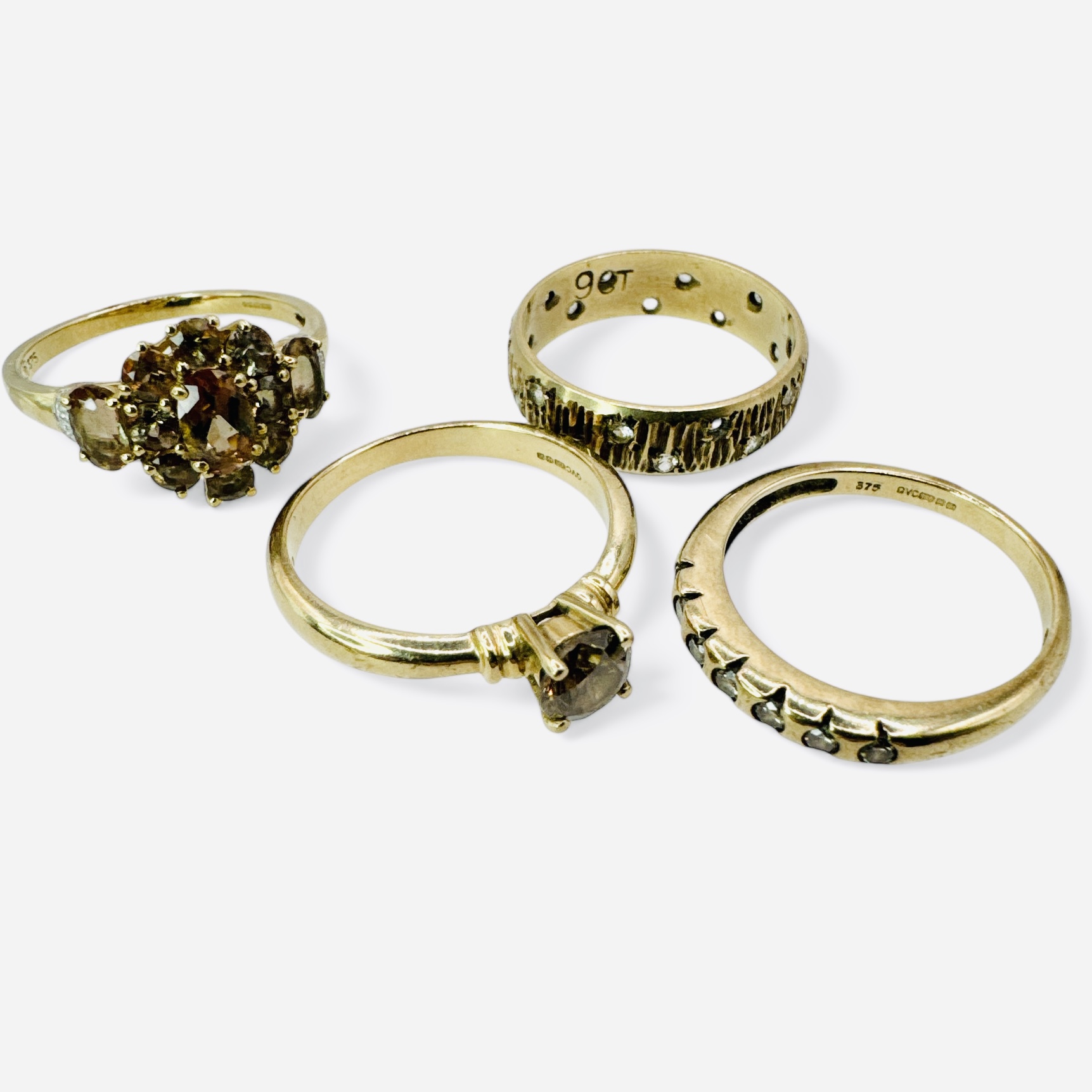 A group of four rings in 9ct gold. Featuring a brown diamond solitaire ring in 9ct yellow gold, size - Image 2 of 2