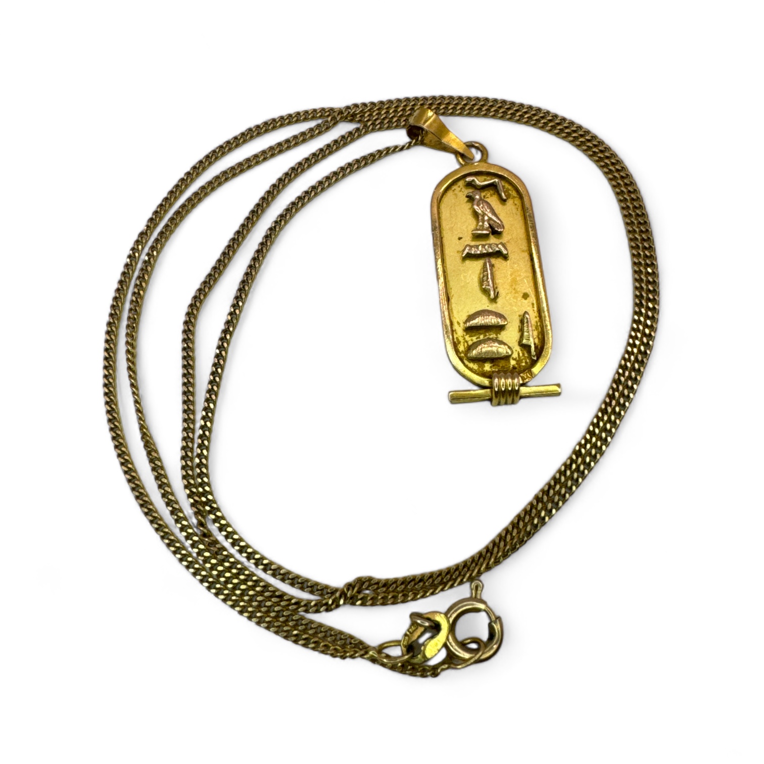 An Egyptian Cartouche panel, testing as 18k gold, reading "Janette" in hieroglyphs. On a chain