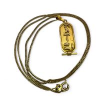 An Egyptian Cartouche panel, testing as 18k gold, reading "Janette" in hieroglyphs. On a chain