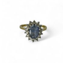 An 18ct gold diamond and pale blue sapphire cluster ring. Size M1/2. Gross weight approximately 2.84