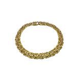 A 9ct yellow gold flat Byzantine chain bracelet. With lobster clasp. Approximate length 19cm.