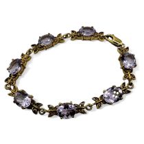 A 9ct Rose de France amethyst set gold bracelet, with foliate scroll work. With lobster clasp.