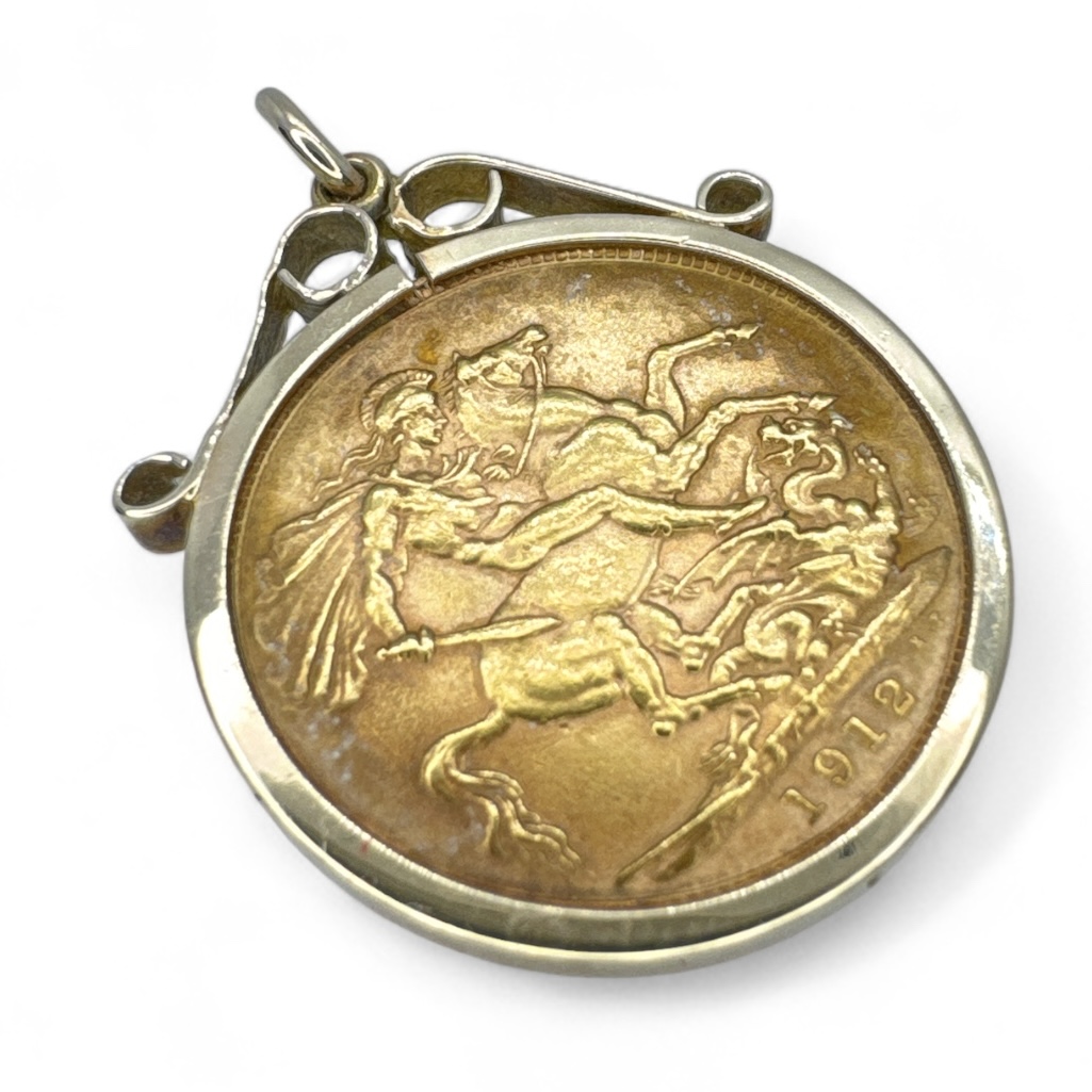 A George V full gold 1912 sovereign in a 9ct yellow gold clip mount. Gross approximate weight 9.7