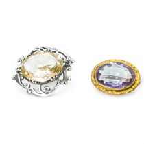Two quartz brooches. Comprising an Amethyst brooch, in yellow precious metal testing as 9K gold;