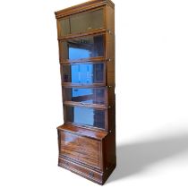 A Globe Wernicke mahogany stacking bookcase with five glazed sections above a cupboard and drawer.