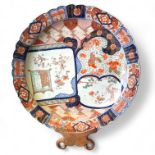 A large Japanese Imari Charger with lobbed rim and cartouche panels.  49cm diameter Firing crack