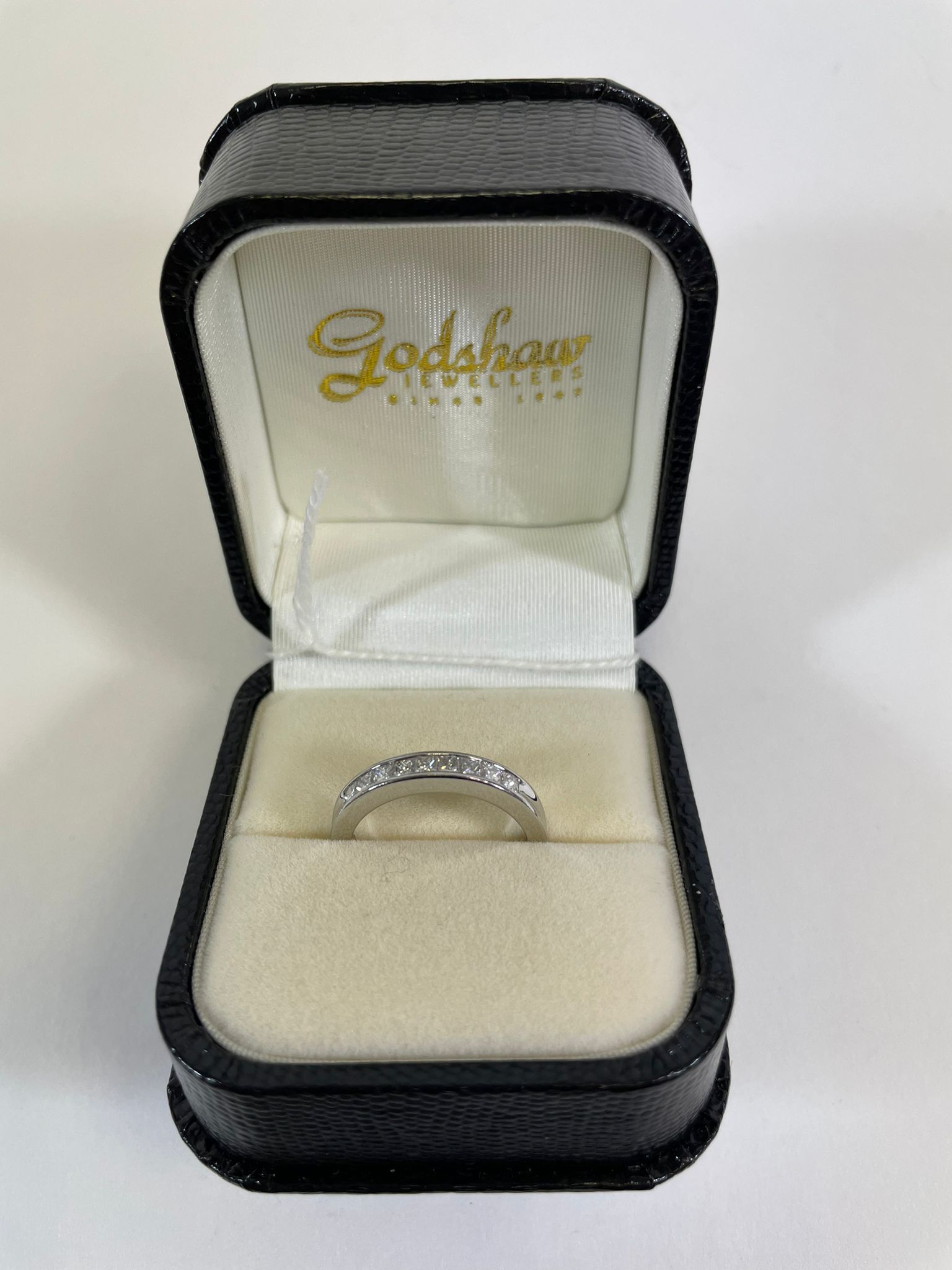 A 950 Platinum channel set diamond half eternity ring. Set with nine princess cut diamonds, - Image 5 of 5