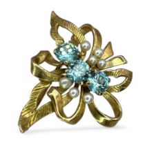 A Zircon and seed pearl spray brooch, set with three round brilliant cut Zircons. ZIrcon is a