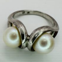A Mikimoto signed double cultured pearl ring. Marked with the M in Scallop stamp and "S" for silver.