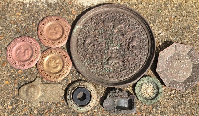 A collection of nine Indian copper/brass plates (9)