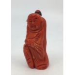 A Chinese carved pink coral scent bottle, carved as a standing figure, height with stopper 7.