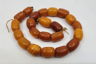 A string of butterscotch amber beads, of near cylindrical form, each approx. length 18mm x 13mm