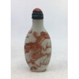 A Chinese snuff bottle with coral mounted stopper