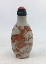 A Chinese snuff bottle with coral mounted stopper