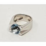 A Cartier 18ct. white gold and aquamarine ring, tension set mixed round cut aquamarine (stone