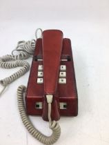 A vintage telephone with read leather cover, (TELE. SR. 1016A, S.T.C. 80/1)