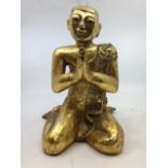 An Asian figure of a monk, H:31cm