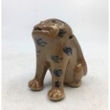 A Chinese Qing dynasty pottery figure of a dog