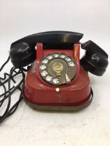 A vintage red bell telephone (a/f)