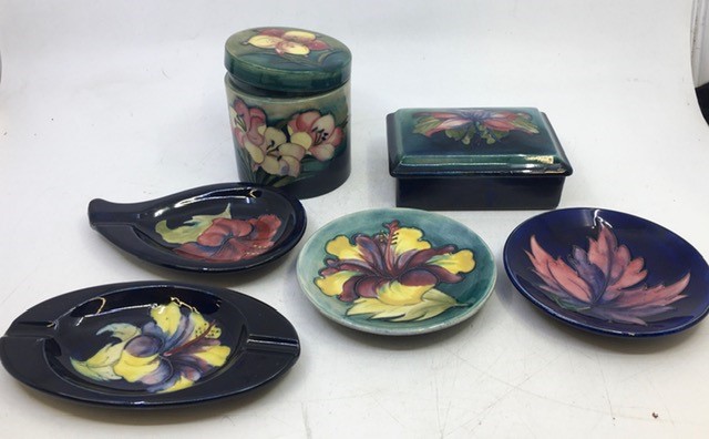 A collection of six Moorcroft pottery to include a lidded jar, a lidded box, and four plates. (6)