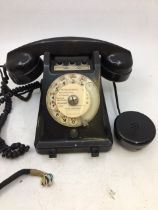 A vintage black bell telephone (PROPRIETE DE L'ETAT R.T.T, APPARELL MOBILE 1+3, 341-1, NO 00058)