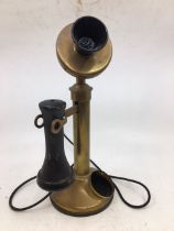 A vintage bronze stick telephone (a/f)
