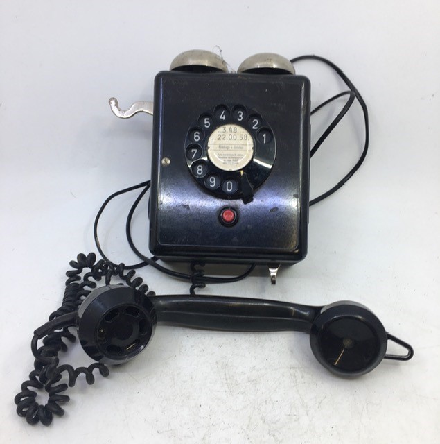 A vintage black bell telephone.